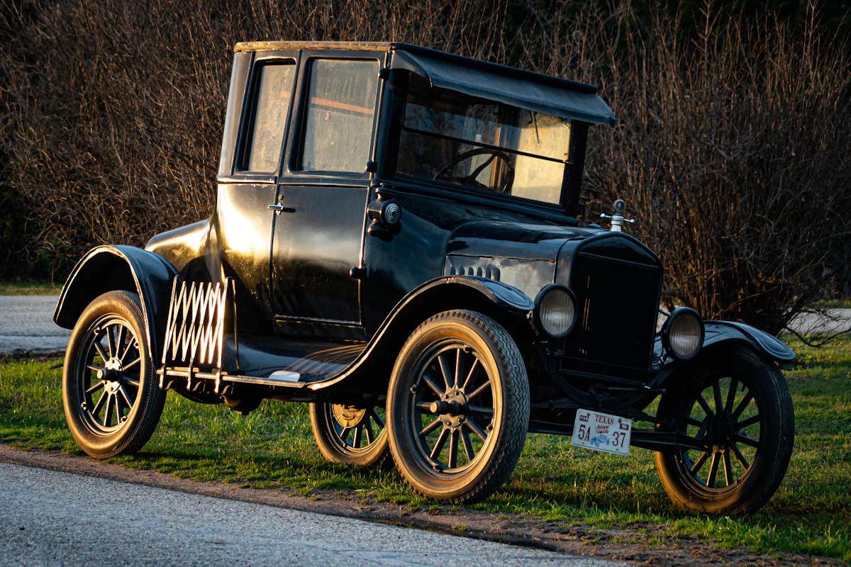 Vintage antique Ford Model T collector car on grass in sunlight